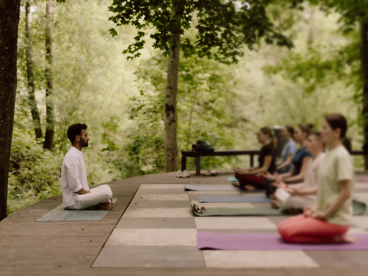 Naveen leading a group meditation in the forest